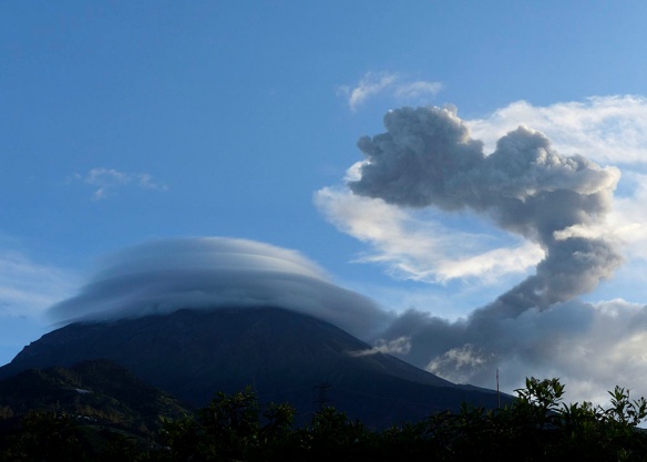 Complexity of wind and cloud formation is illustrated by this picture of our erupting Tungurahua volcano. Strong surface winds are coming from the left, pushing the ash cloud (which emerged from near the top of the volcano) to the right. Then, as the ash cloud rose, it reached a layer of air moving more slowly to the right. Then it hit a higher layer of relatively calm air and went straight up, until hitting a layer of air moving strongly from right to left. Then the ash cloud reached a layer of calm air and began to billow straight up.  In contrast the lenticular cloud of water vapor covering the volcano's summit is in dynamic equilibrium, giving the appearance of not moving, in spite of the surface winds. It is constantly being created on its leading (left) edge and destroyed on its trailing edge.  Photo: Lou Jost/EcoMinga.